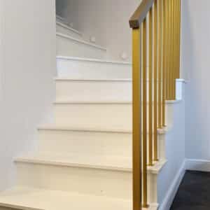 Gold railings with wooden armrest