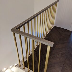 Gold railings with wooden armrest