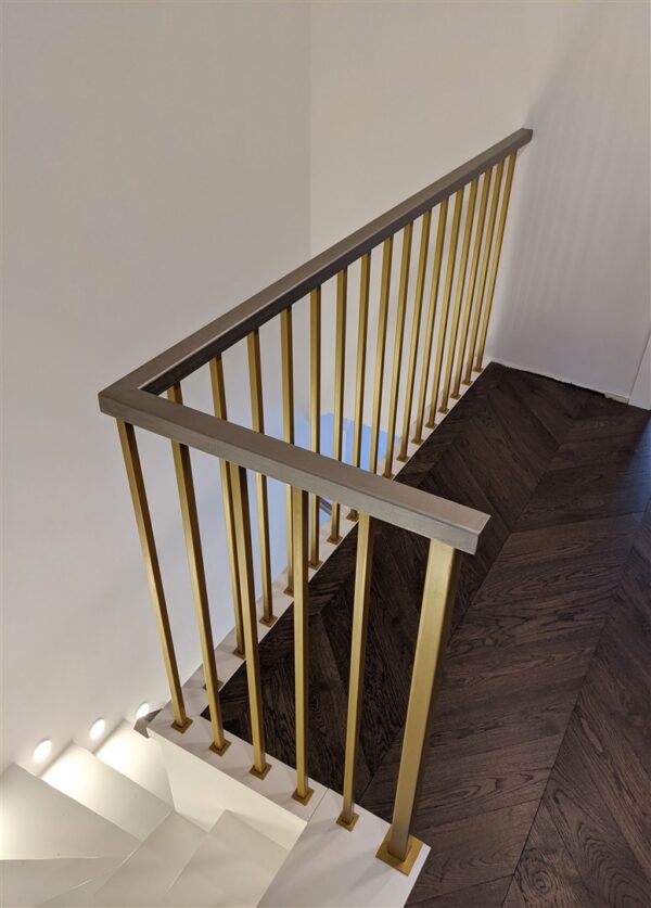 Gold railings with wooden armrest